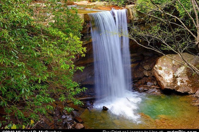 a large waterfall over some water