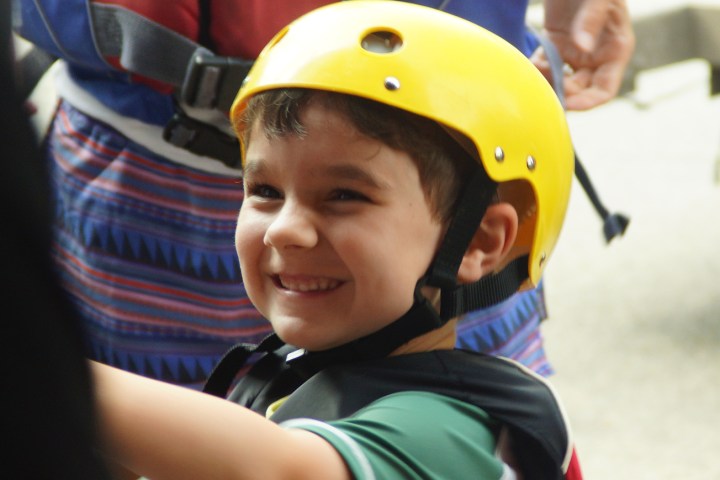a little boy wearing a helmet