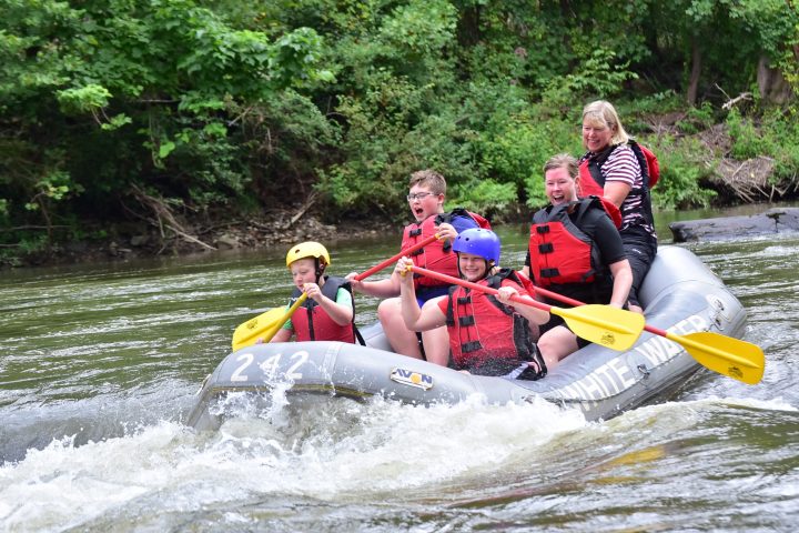 a group of people riding on a raft in a body of water