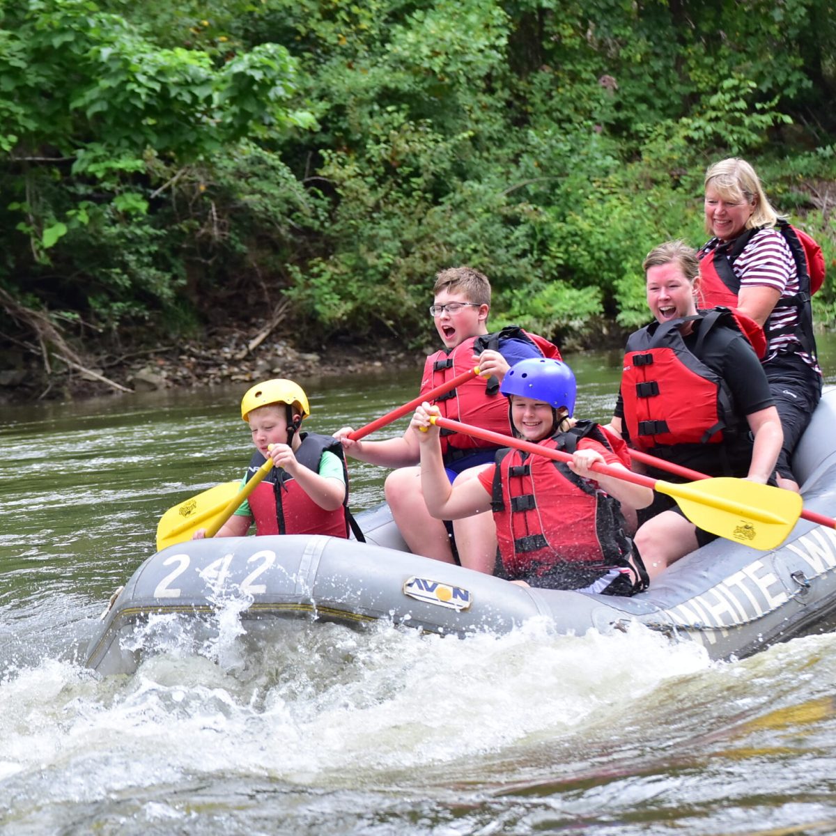 a group of people riding on a raft in a body of water