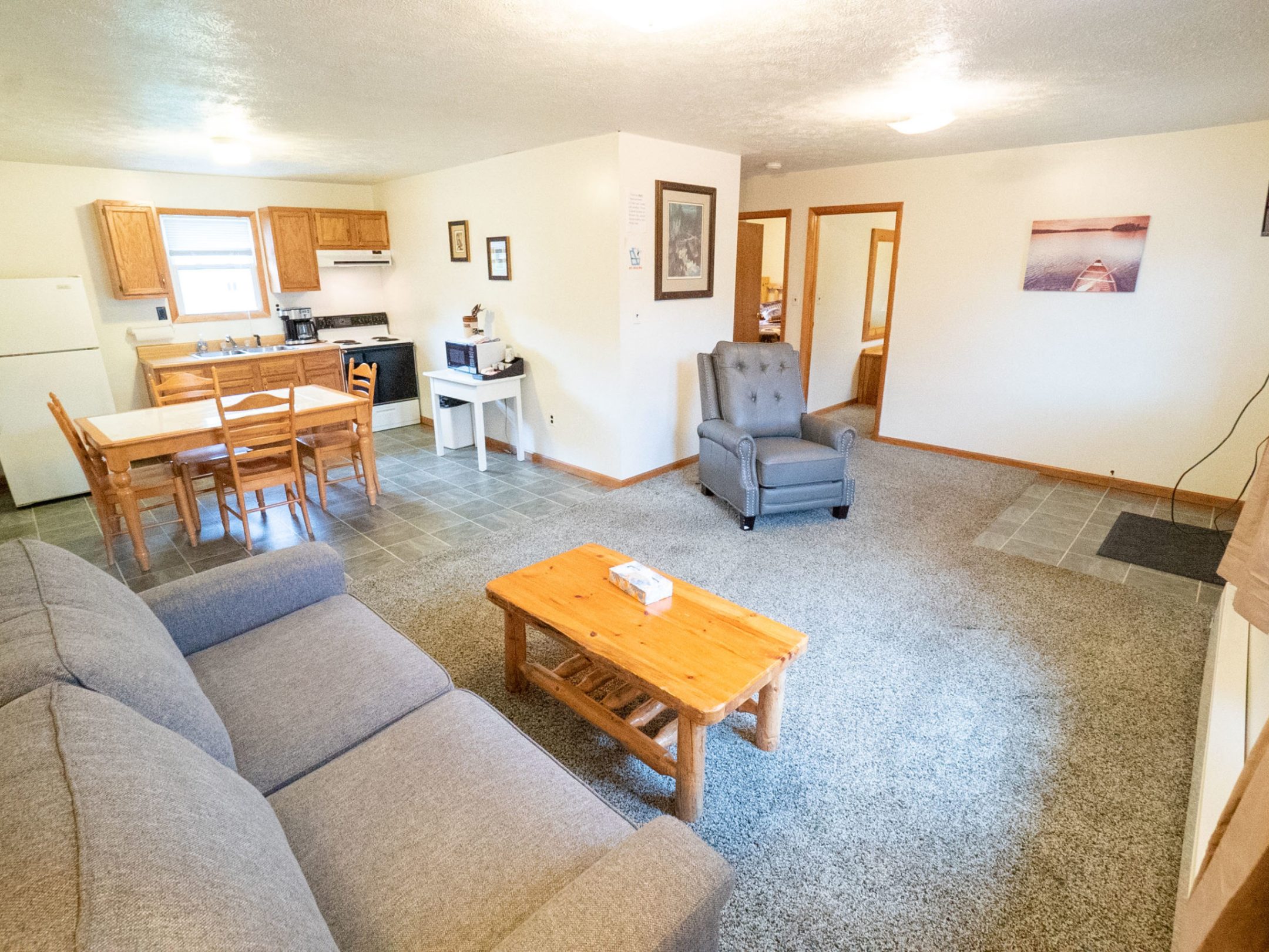 a living room filled with furniture on top of a wooden chair