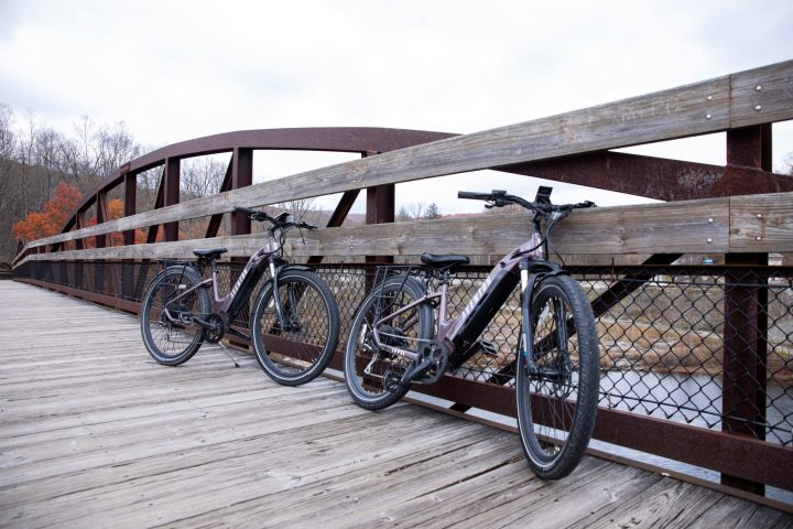 a bicycle leaning against a wooden fence