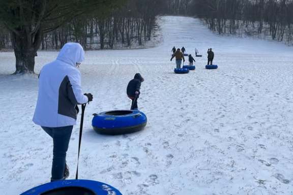 a group of people playing frisbee in the snow