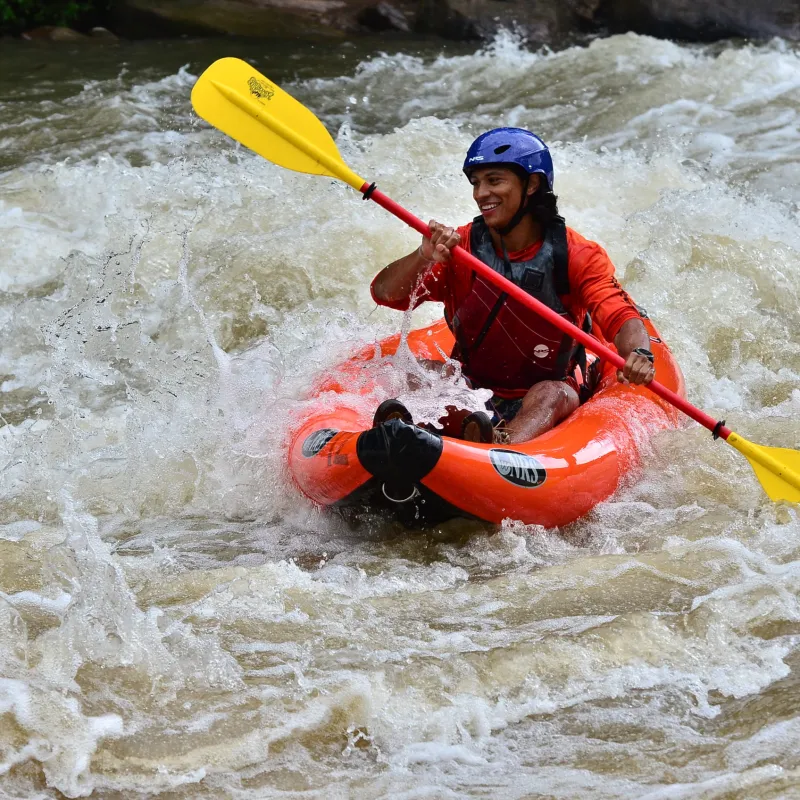 a man riding on a raft in a body of water