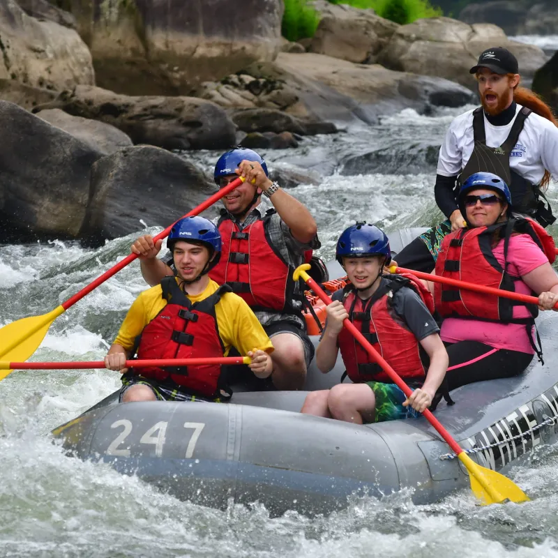 a group of people riding on a raft in a body of water