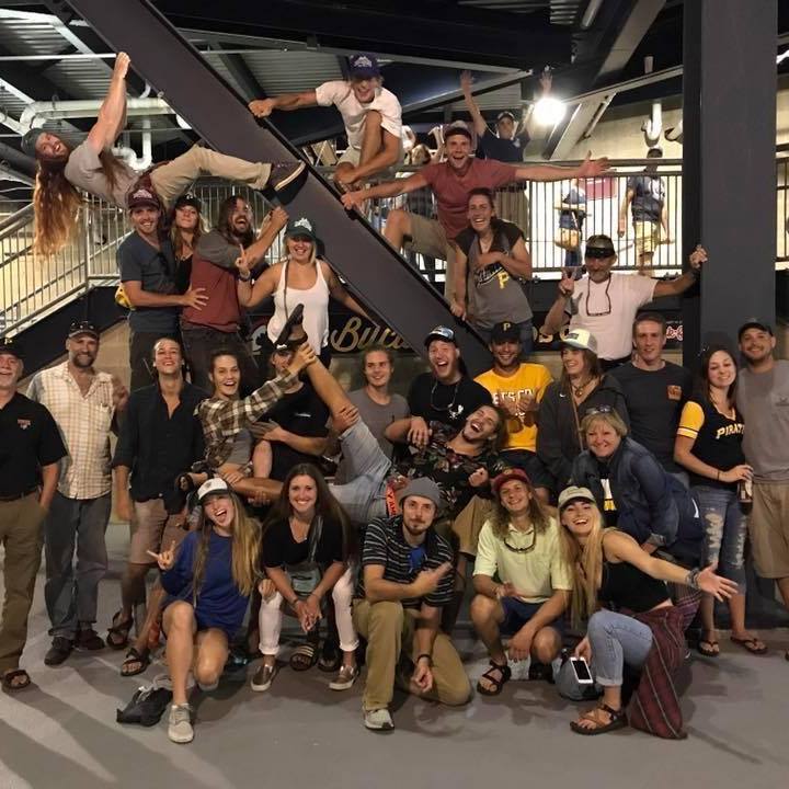 a group of people standing in front of a crowd posing for the camera