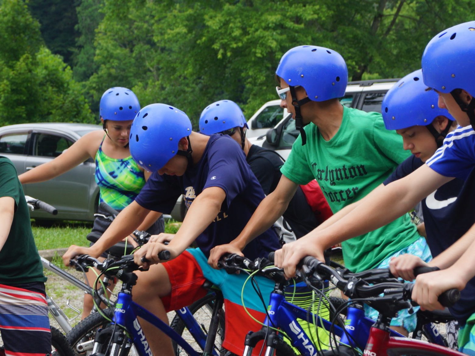 a little boy wearing a helmet and riding a bicycle