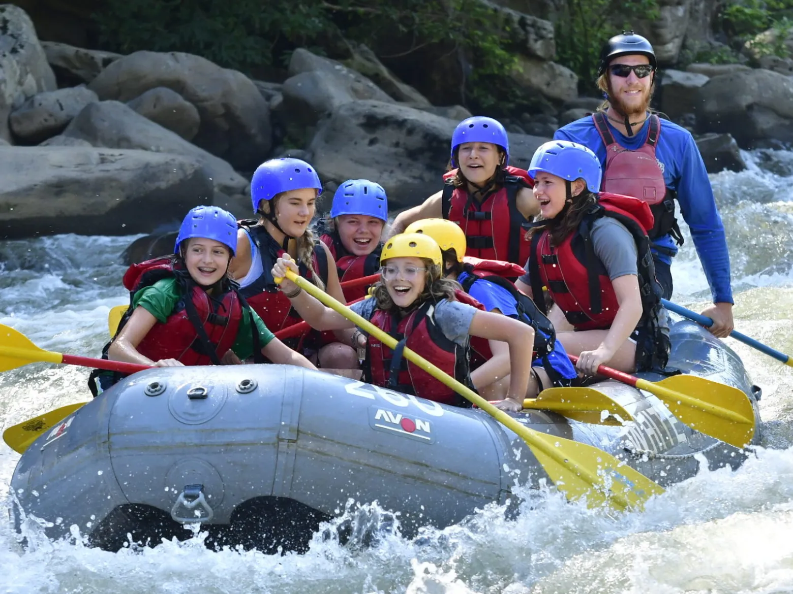 a group of people riding skis on a raft in the water