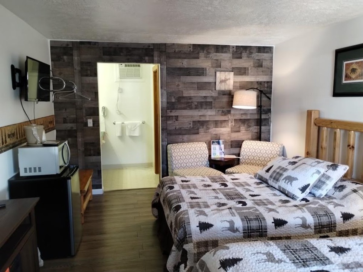 a bedroom with a bed and desk in a room