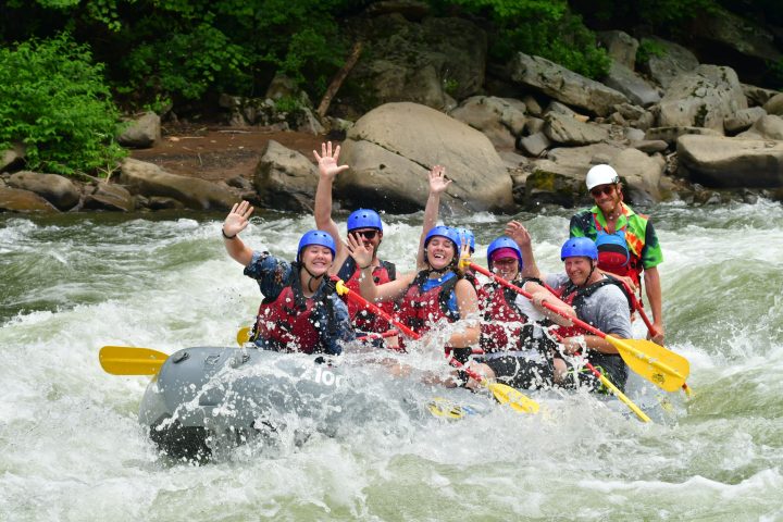 a group of people on a raft in a body of water