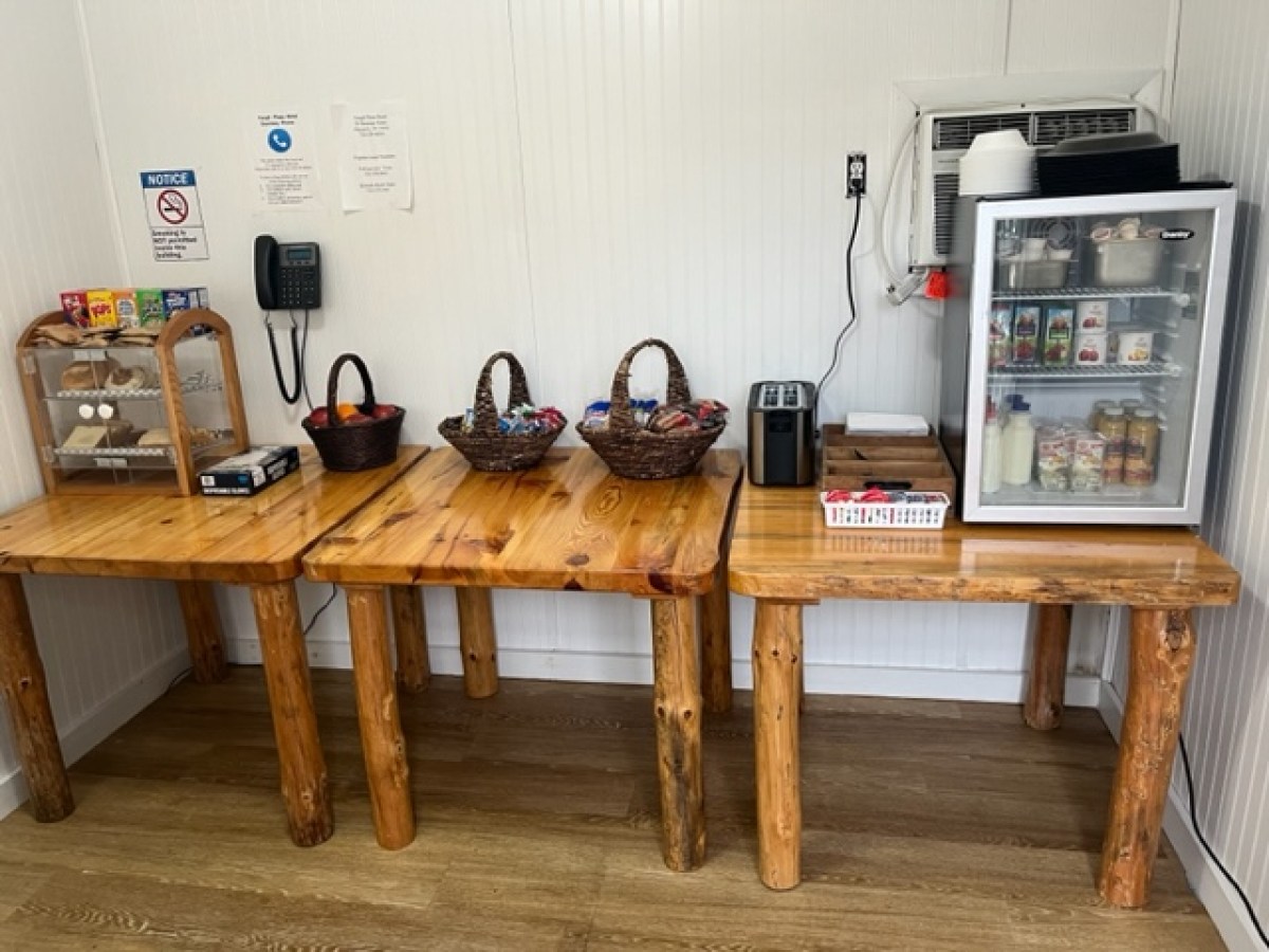 a kitchen with a microwave on top of a wooden table