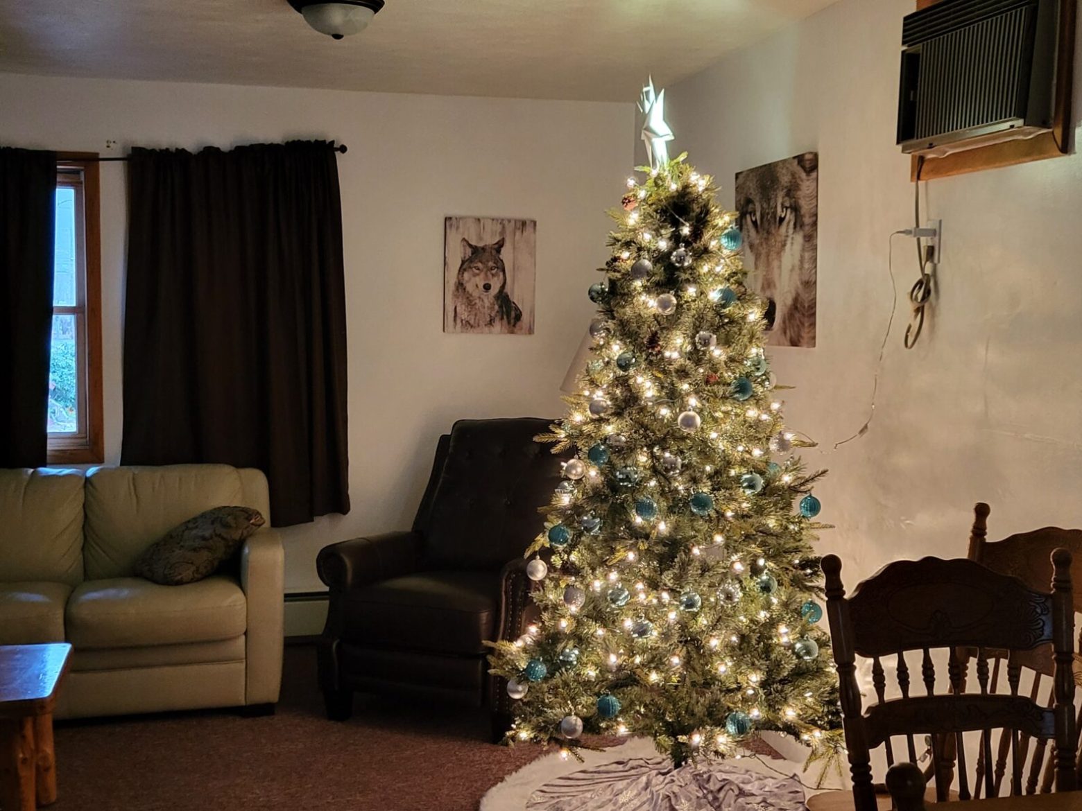 a living room with a sofa chair and looking at the camera