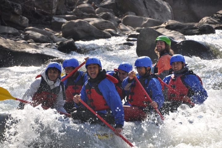 a group of people riding skis on a raft in the water