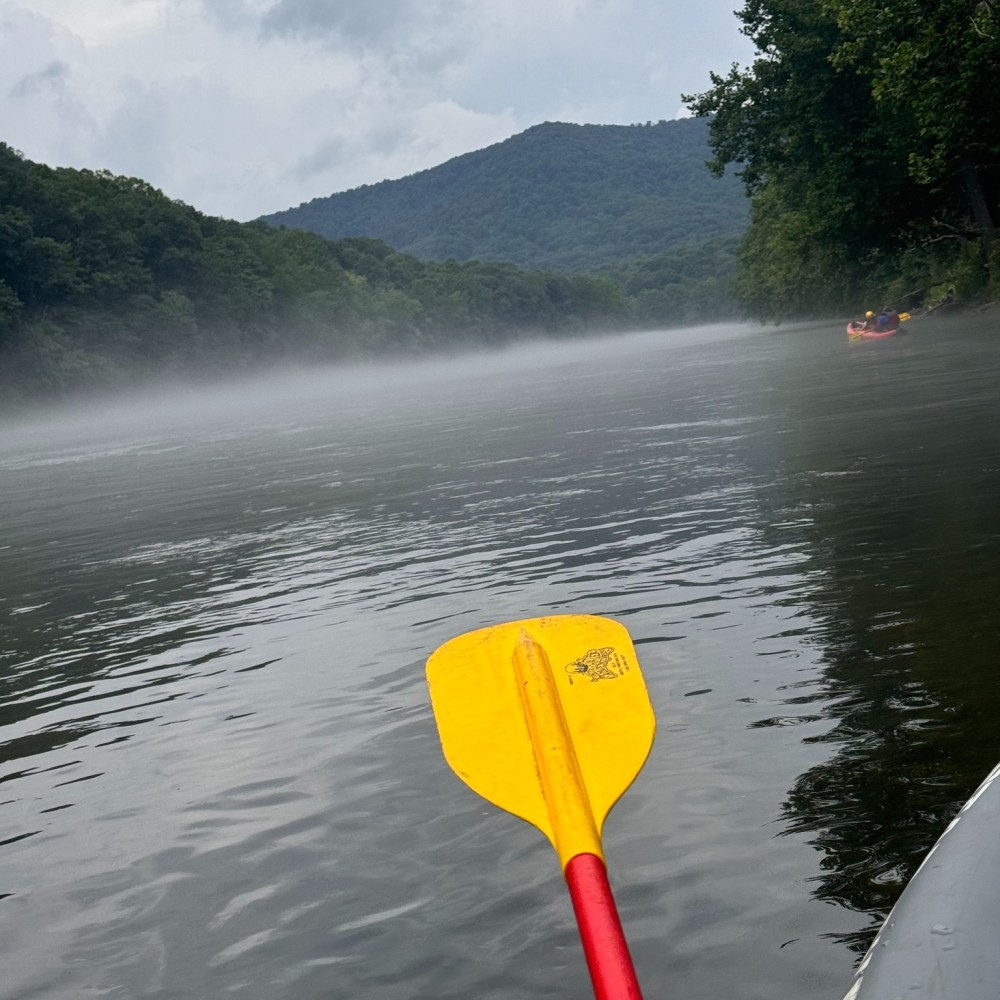 a person standing next to a body of water