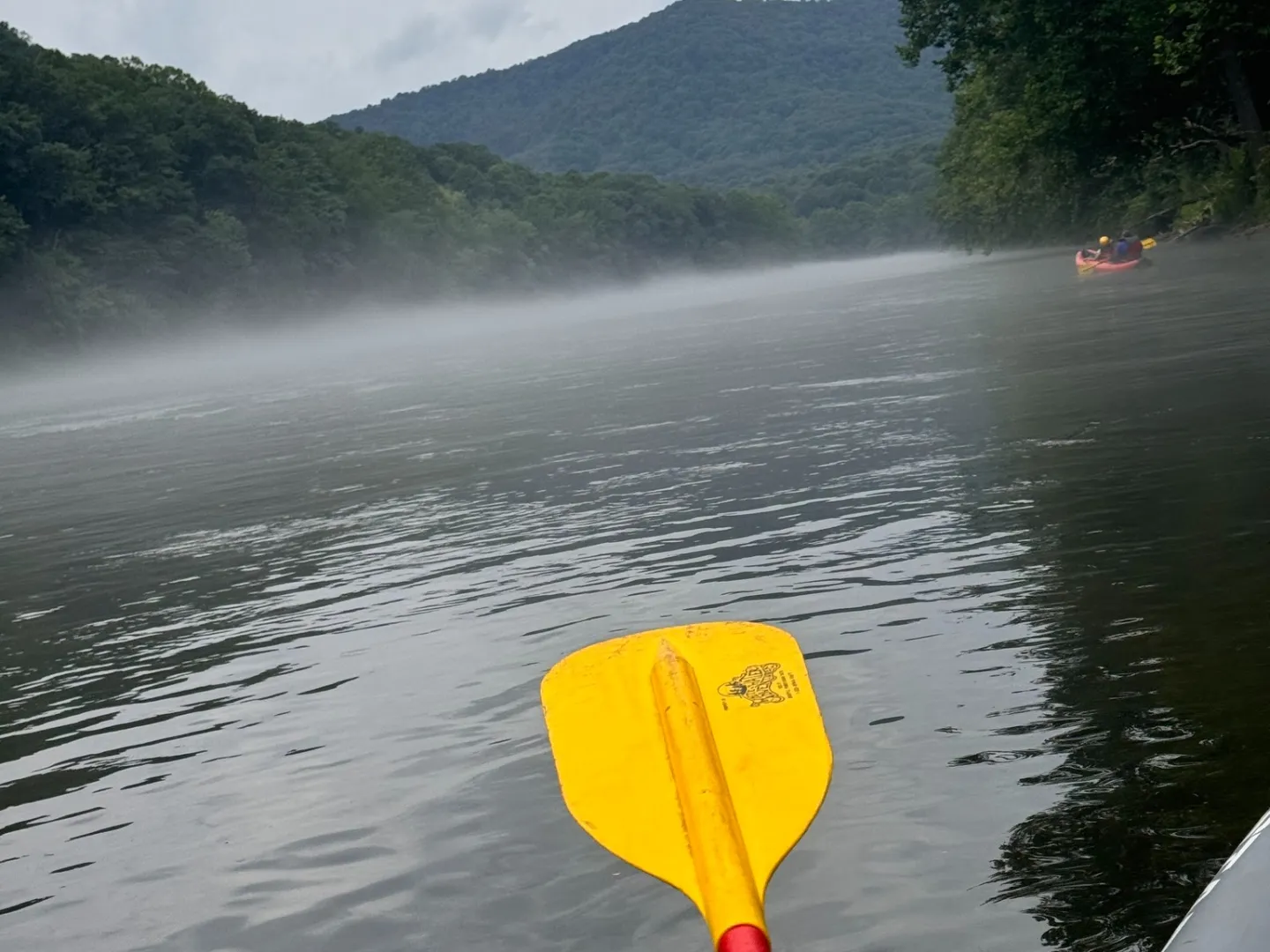 a person standing next to a body of water