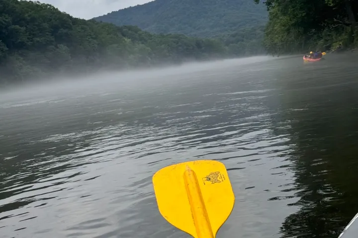 a person standing next to a body of water