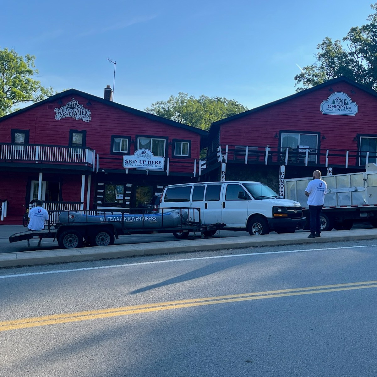 a house that has a sign on the side of a road